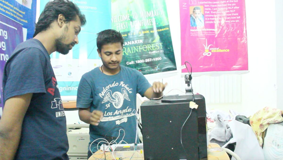 Akash and Varun with one of our early prototypes for the 1 cam design. The camera is mounted on a 3D printer with SMPS powering its motors. The whole setup was 2 foot by 1 foot wide.